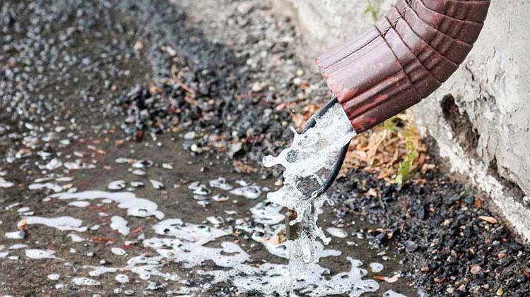 Water pouring out of a downspout